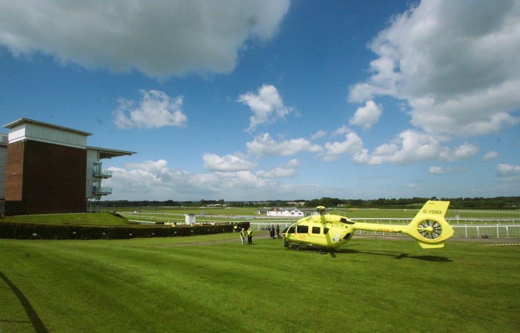 Yorkshire Air Ambulance lands at Wetherby Racecourse.